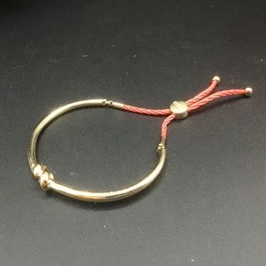 Guess “Love Knot” Bangle Bracelet in gold metal and Orange twisted Rope